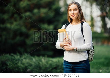 Student Girl Portrait Holding Books Wearing Backpack Outdoor In Park Smiling Happy Going Back To Sch