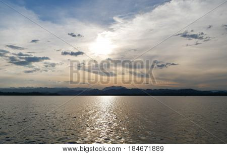 beautiful landscape with sky and clouds reflected into lake.