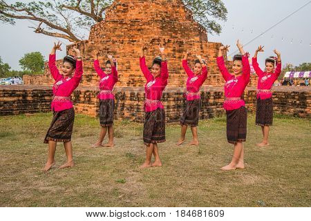 KALASIN THAILAND - FEBRUARY 20 2016: Girl dancers with local dress doing Thai Northeastern traditional dance at Yaku Pagoda to celebrate Buddism event in Kalasin