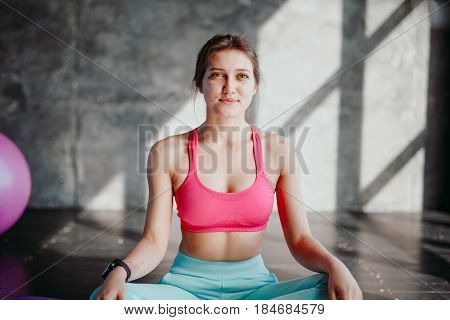 Woman Practicing Yoga In Lotus Pose Indoor. Fit Girl In Sportswear Sitting In Padmasana