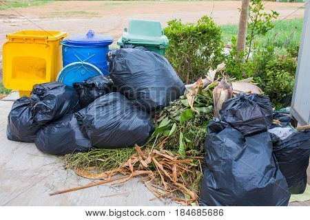 Piles of garbage in plastic bin bags (trash, waste) in City.