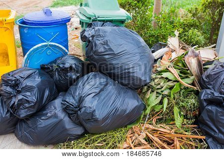 Piles of garbage in plastic bin bags (trash, waste) in City.