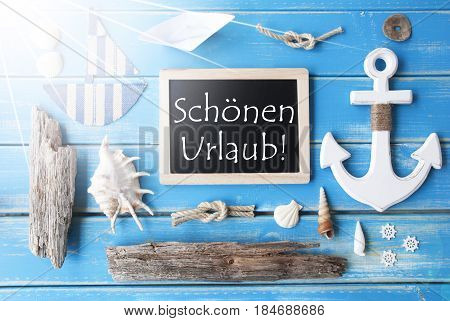 Flat Lay Of Chalkboard On Blue Wooden Background. Sunny Nautic Or Maritime Summer Decoration As Holiday Greeting Card. German Text Schoenen Urlaub Means Happy Holidays
