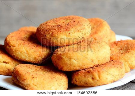 Spicy chickpea cutlets on a plate. Roasted cutlets cooked with chickpeas puree. Simple, tasty and hearty recipe idea. Rustic stile. Closeup