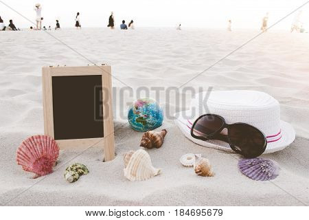 Straw Hat, Sun Glasses, World Ball Toy, Seashell And Blank Blackboard For Text On Clean Sand Beach W