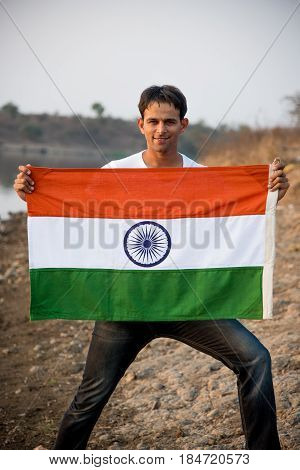 indian man holding indian flag or tricolour