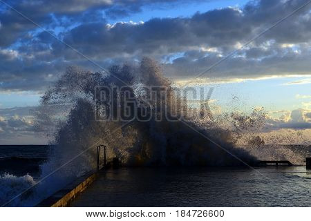 Splashing through a breakwater from a wave during a storm