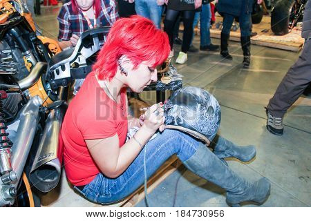 St. Petersburg Russia - 15 April, A woman is engaged in aerography,15 April, 2017.
International Motor Show IMIS-2017 in Expoforurum.
Visitors and participants of the annual moto-salon in St. Petersburg.