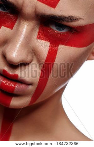 Angry Woman with tribal red painted Forms on her Face