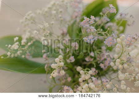 Very delicate spring bouquet of lilies of the valley and forget-me-nots