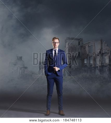 Businessman standing on apocalyptic background. Crisis, default, setback concept.