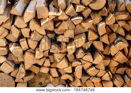 firewood background - split hardwood kiln-dried. split firewood in the stack