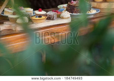 Close up of sweet food arranged on wooden table at cafe shop