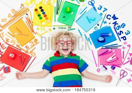 Child With School And Drawing Supplies. Student With Book.