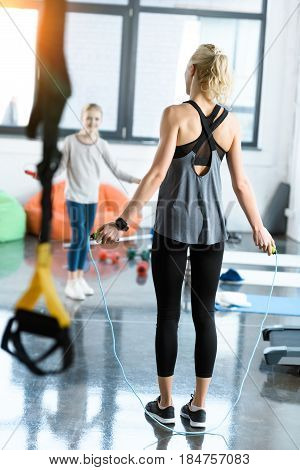 Young Fitness People Exercising With Skipping Ropes At Sports Center