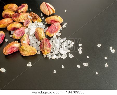 Heap Of Inshell Pistachios And Peeled Pistachios With Large Salt Crystals
