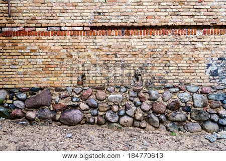 Yellow brick wall background with stone basement