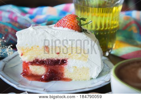 coffee cup and delicious cake strawberry and relax time moblie on table in coffee shop