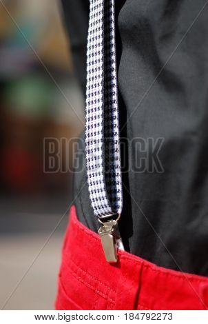 man in red trousers wirt suspenders ..