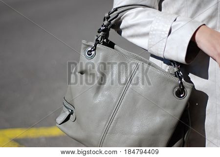 wonam on the street with grey leather handbag