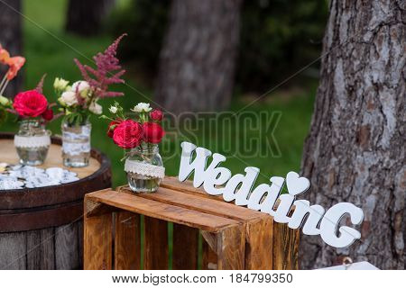 Beautiful Wedding Ceremony Outdoors. Decorated Chairs Stand On The Grass. Wedding Arch Made  Flowers