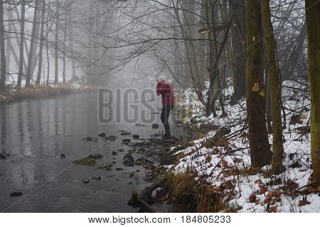 a girl in fog at the river