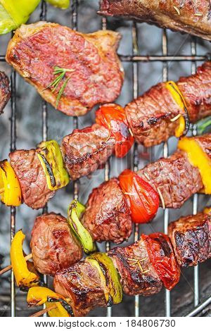 Grilled pork ribs and kebabs on a grill