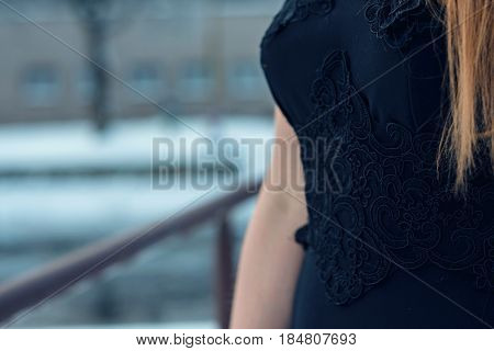 woman posing in black dress on the bridge