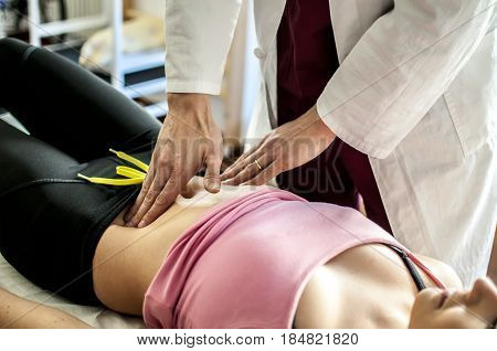 medical doctor visits a young girl for an abdomen check up