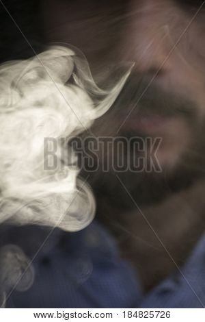 Man Vaping Electronic Cigarette With Clouds.