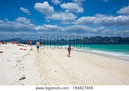 CRABI PROVINCE THAILAND - FEBRUARY 02 2015: Tourists relaxing on the white sand beach of Andaman sea at Krabi province Thailand
