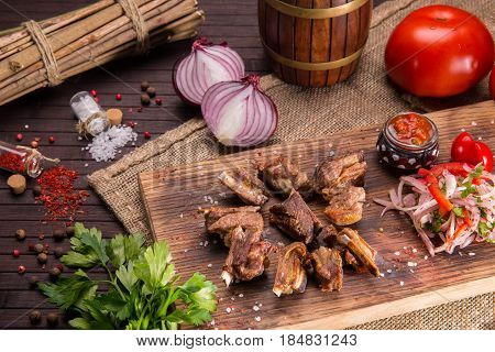 Sunflower seeds mutton with ajika sauce, with tomatoes, onions and greens