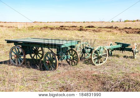 Country life. Old wooden carts without a horses stand at the field