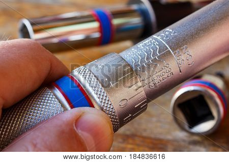 Torque wrench adjusting by mechanic in the workshop
