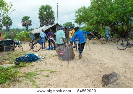 SRI LANKA - Mach 23: Local fishermen pull a fishing net from Indian Ocean on Mach 23, 2017 in Kosgoda, Sri Lanka. Fishing in Sri Lanka is the way they earn their living.