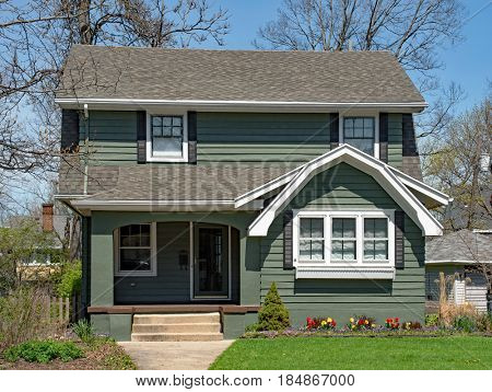 Older Two Story Home with Spring Flowers
