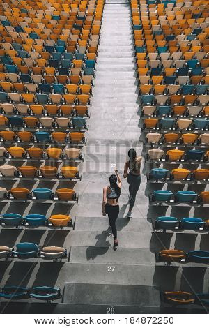Two Sportswomen Running On Stadium Stairs, Running Women Concept