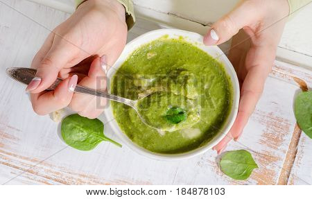 Woman Hands With Bowl Of Green Spinash Soup.