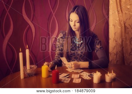 Young woman with divination cards in room