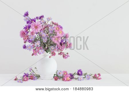 flowers in ceramic vases on white background