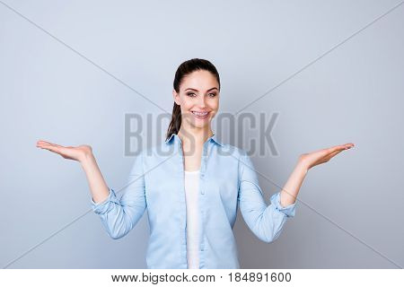 Pretty Smiling Woman In Blue Shirt Isolated On Gray Background Asking You To Make A Choice Between T