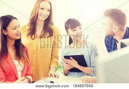 business, startup, education and people concept - happy creative architect team or students with blueprint working at office