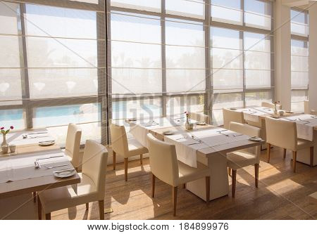 Empty hall of the restaurant with tables ready for the lunch