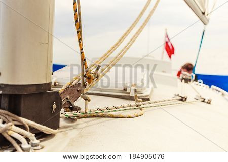 Detailed close up of down side of sail mast on boat during sea cruise. Yachting sailing objects concept.