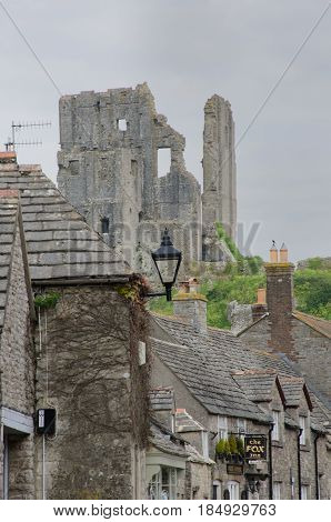 Corfe Castle Dorset United Kingdom -23 April 2017: Corfe village with castle in background