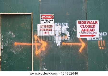 danger side walk closed post no bills signs on construction urban wall