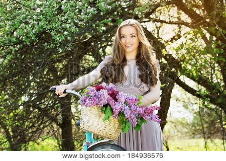 Portrait Of Young Beautiful Girl With Long Hair In Bright Dress With Flowers In Basket On Vintage Bi