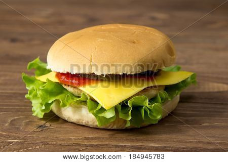 Tasty Burger With Cheese Isolated On Wooden Background