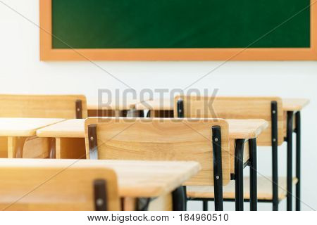 School empty classroom with desks chair wood with greenboard in high school education concept