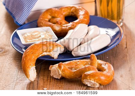 Bavarian pretzels with saisages on cutting board.